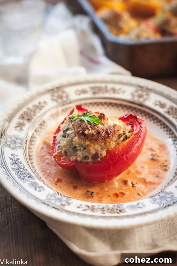 Healthy comfort food dinner with perfectly roasted stuffed peppers, showcasing a delicious golden brown char and a creamy tomato sauce.