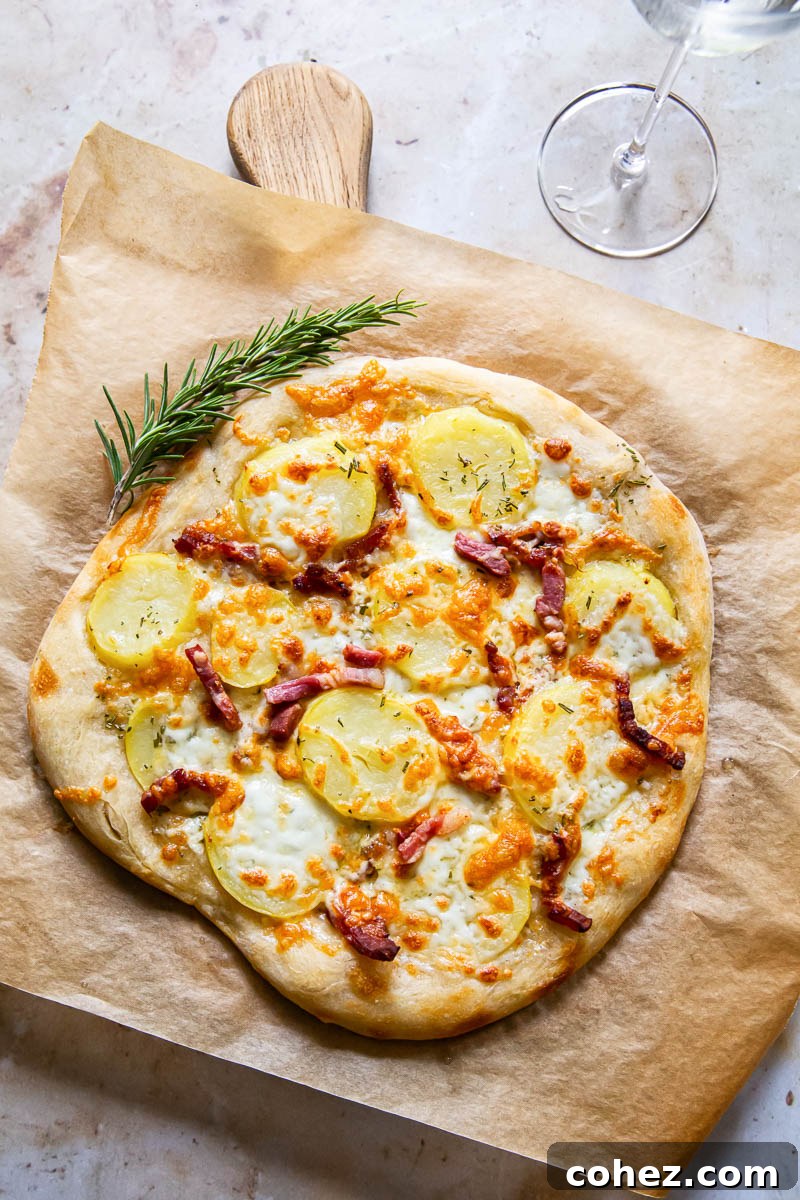 top down view of pizza bianca on brown parchment paper on top of wooden board, ready to be served