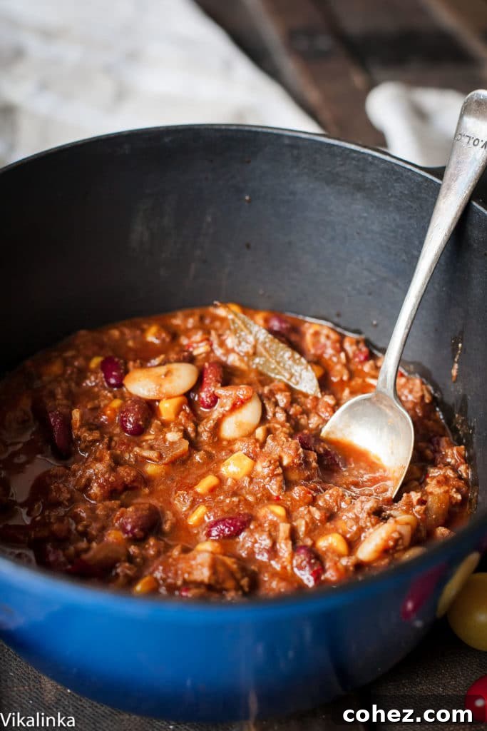 Authentic Lone Star Chili 5 A pot of the dish with a serving spoon
