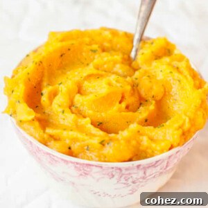 Sweet potato and swede mash in a bowl on white background