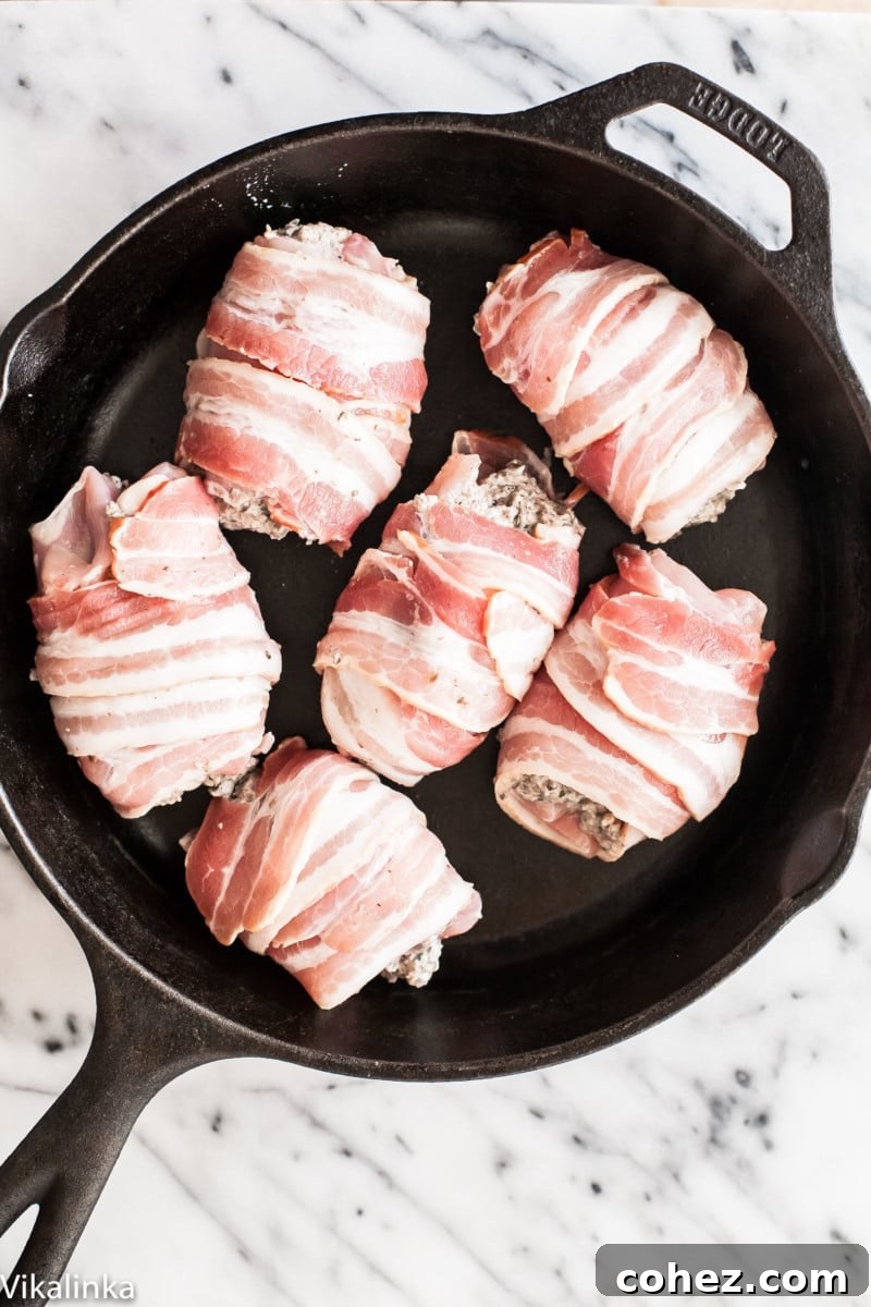Process shot of chicken thighs being prepared for stuffing in a pan, showing the raw chicken ready for filling