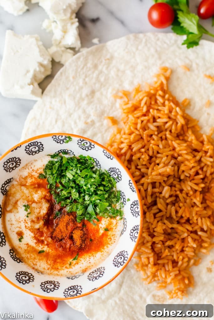 A Peri Peri Rice and Chicken Wrap laid open on a table, showcasing a bowl with the topping mixture