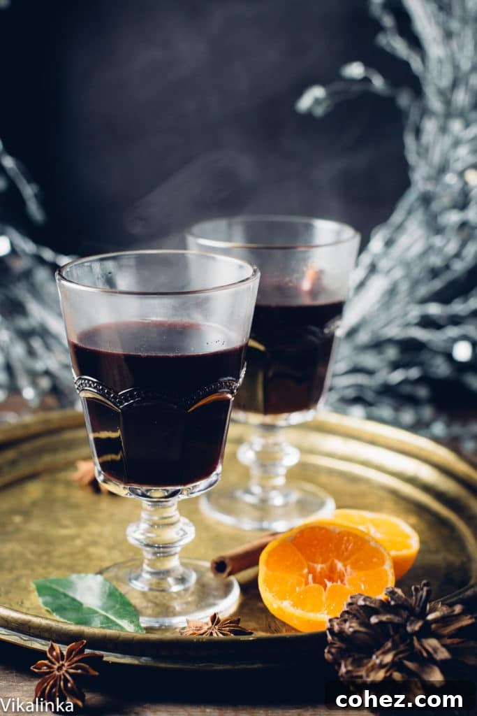 mulled wine in glasses on tray with orange halves, ready for serving