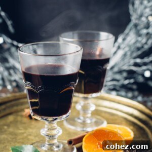 mulled wine in glasses on tray with orange halves