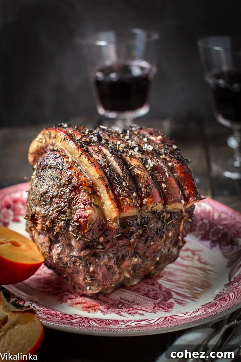 A cooked pork roast, beautifully sliced and served on a platter, alongside an artfully opened ripe persimmon, hinting at the warm, sweet sauce.