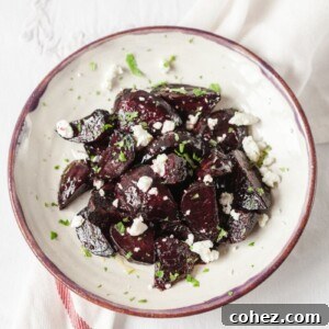 Top down view of beets with goats cheese and mint on a plate
