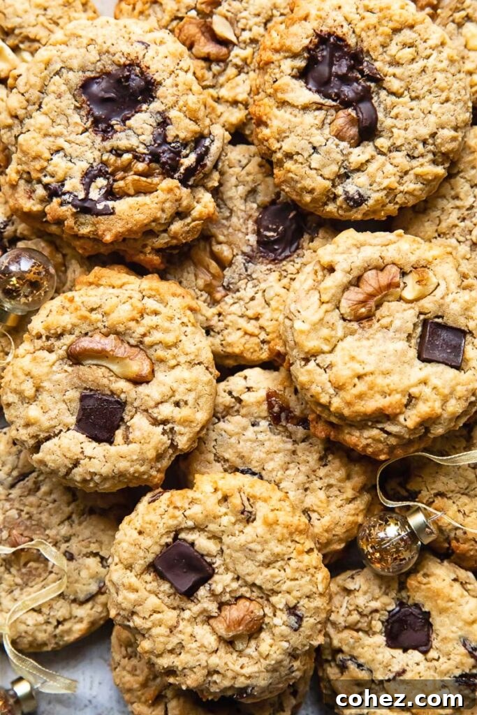 Top down shot of many cowboy cookies stacked on top of each other on a cutting board