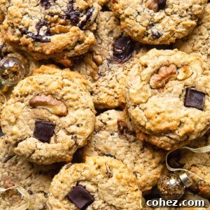 Top down shot of many cowboy cookies stacked on top of each other on a cutting board