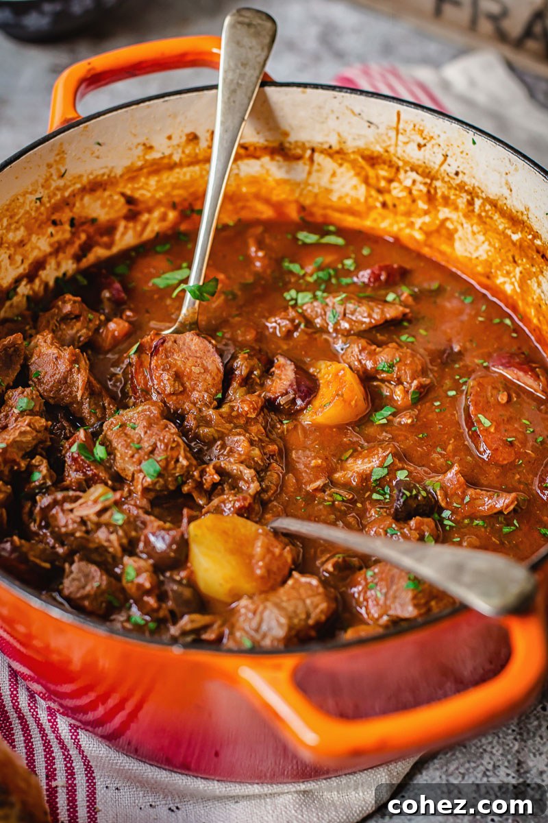 Vibrant Russian Solyanka beef stew simmering in an orange Dutch oven, ready to be served.