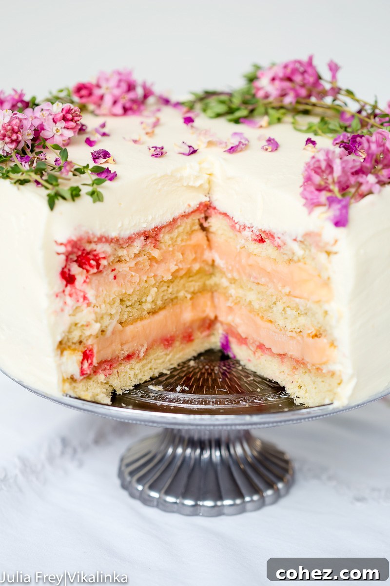 layer cake with a slice cut our exposing vanilla sponge and rhubarb curd filling