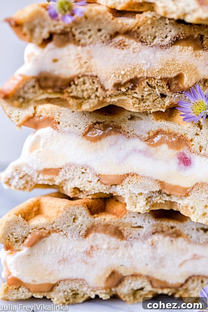 Stack of freshly made waffle ice cream sandwiches, seen close up with a tempting view of the layers.
