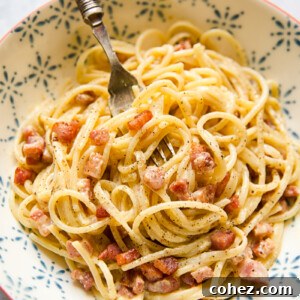 Effortless Cream-Free Carbonara Sauce 7 Bowl of spaghetti carbonara with a fork