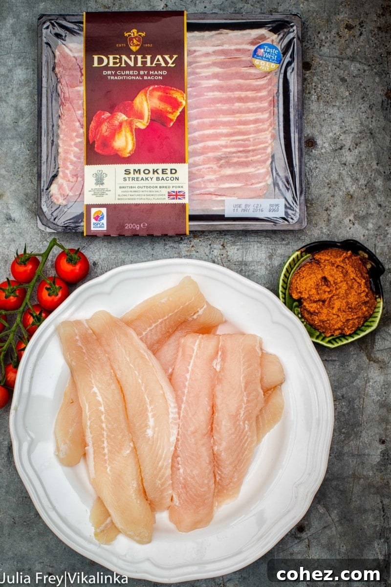 Fish Fillets in Bacon Blankets with Sun-Dried Tomato Pesto 4 Two pieces of bacon-wrapped fish with sun-dried tomato pesto on a baking tray before going into the oven. A simple 4-ingredient recipe for a quick and easy dinner.