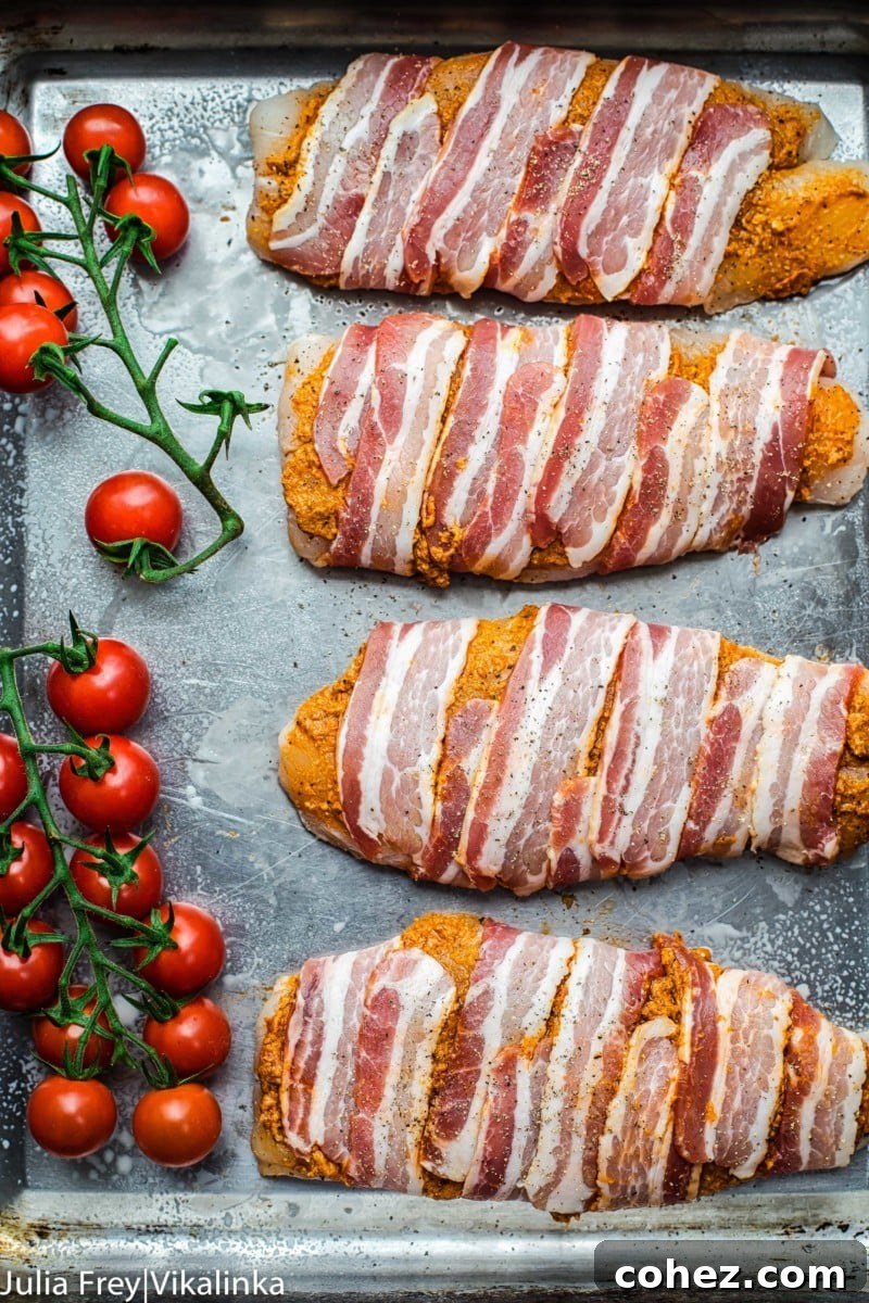 Fish Fillets in Bacon Blankets with Sun-Dried Tomato Pesto 5 Cooked bacon-wrapped fish with sun-dried tomato pesto and roasted cherry tomatoes on a baking tray, ready to be served. A delicious and easy 4-ingredient dinner recipe.