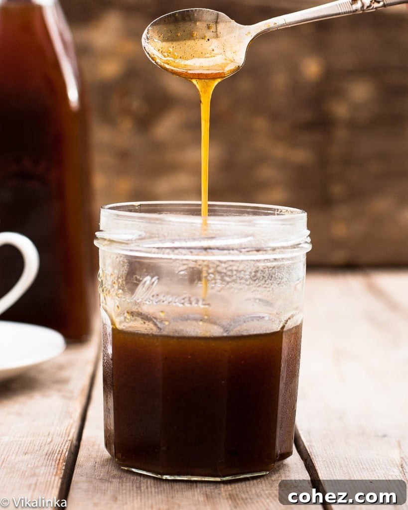 Liquid Autumn Spice 2 Spoon pouring pumpkin spice syrup into a jar