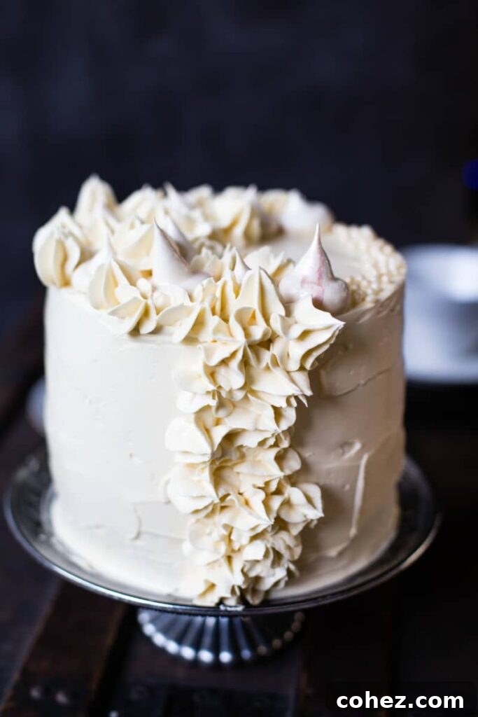 Elegant Earl Grey meringue cake adorned on a cake stand, ready to be served.