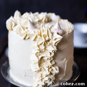 The finished Earl Grey meringue cake on a cake stand, ready for serving.