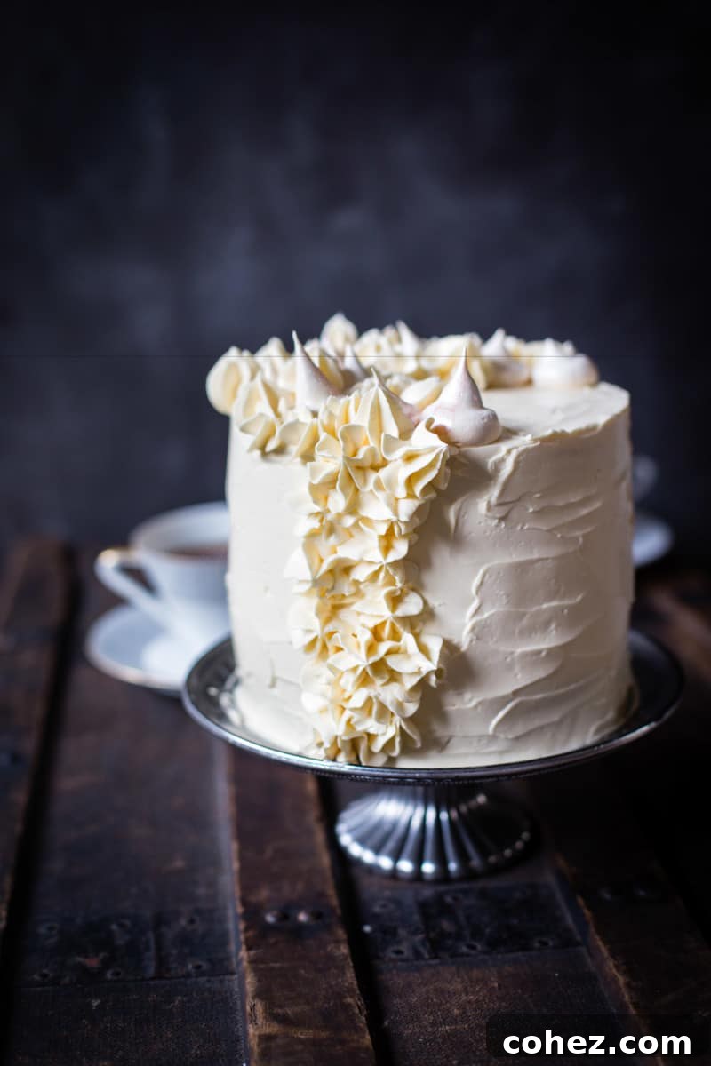 The finished cake proudly displayed on a cake stand, set against a rustic wooden surface, highlighting its artisanal charm.