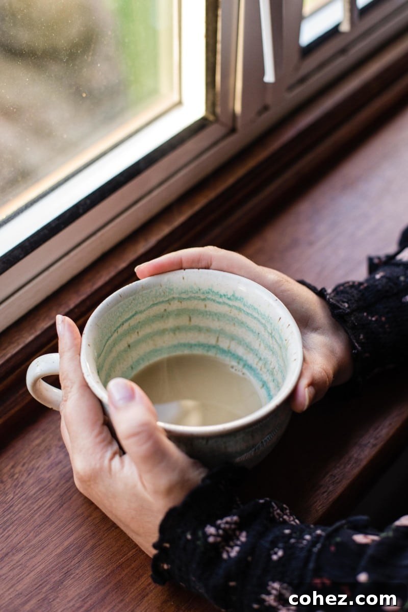 Close-up shot of a chai latte in a clear glass cup, highlighting its creamy texture and rich color, ready to be enjoyed.