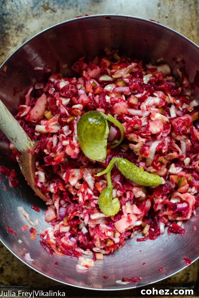 Close-up of beetroot and sauerkraut salad with diced pickles, showcasing the textured ingredients.