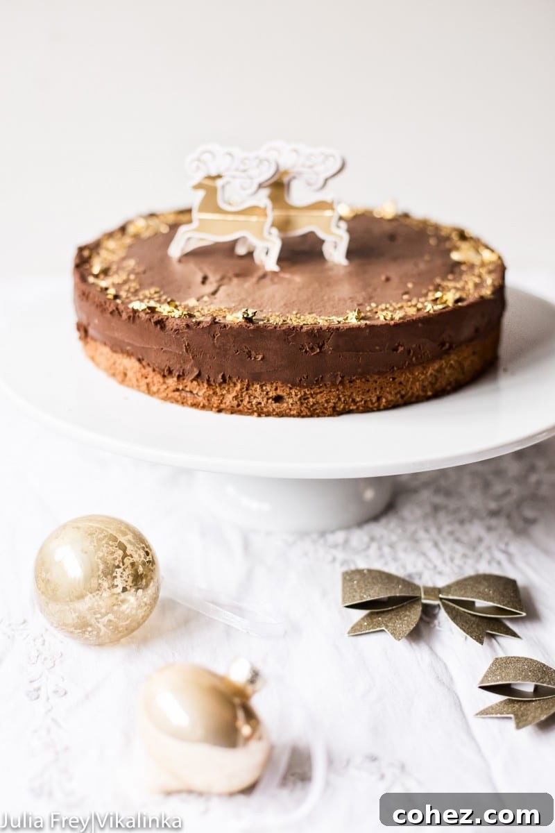Velvet Chocolate Truffle Dream 6 chocolate truffle cake decorated with edible gold leaf on white cake stand, presented beautifully.
