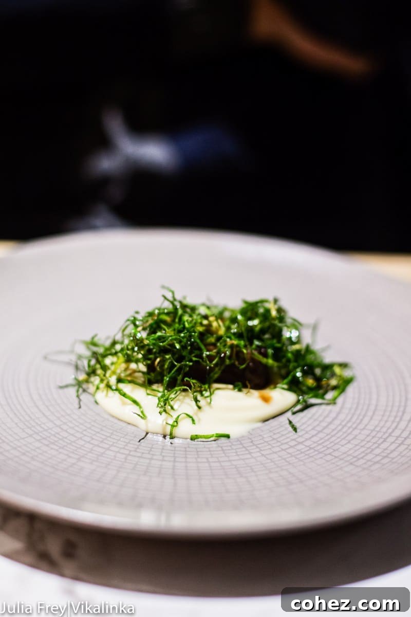 An artfully composed dish, possibly a starter, featuring delicate ingredients and precise placement on the plate.