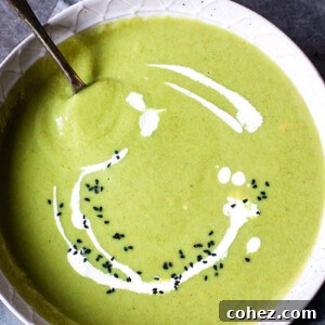 Top-down view of a bowl of Cream of Broccoli Soup with Smoked Gouda