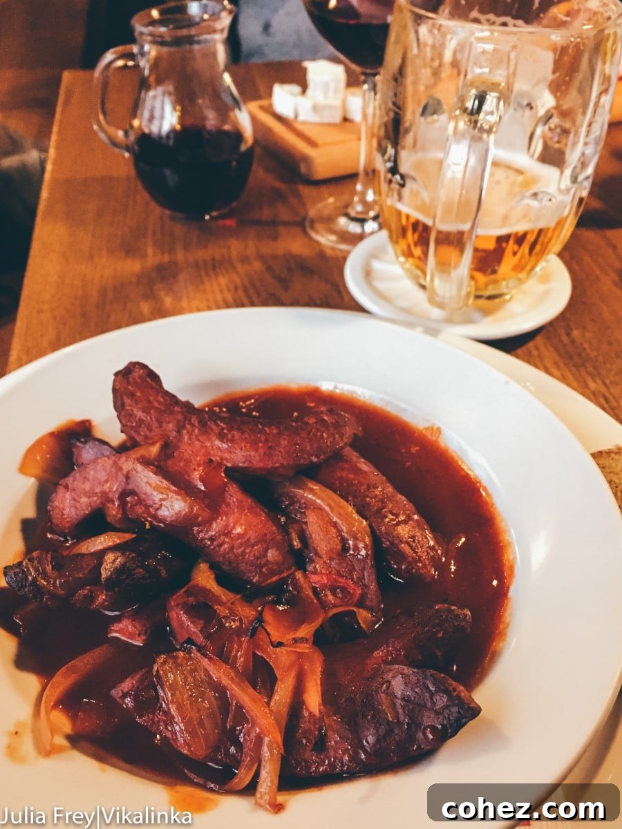 A hearty plate of traditional Czech food, possibly goulash with dumplings