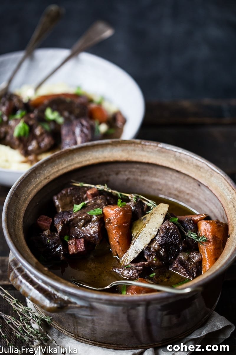 Beef Bourguignon served in a large ceramic serving dish, ready for family style dining