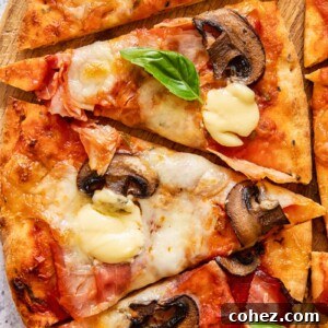 Pizza cut into four slices, garnished with fresh basil