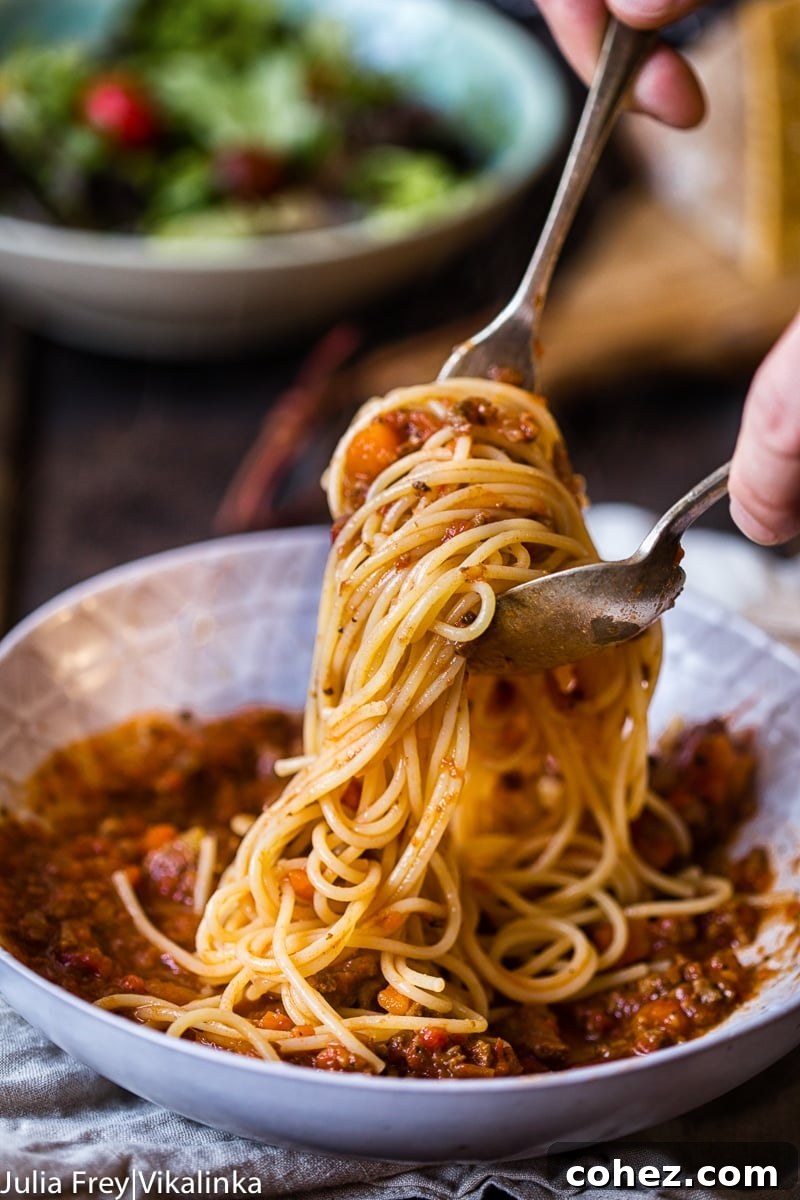 Savory Slow Cooked Bolognese Ragu 5 A top-down view of slow cooker beef bolognese sauce, showcasing its rich texture and color, simmering to perfection in the appliance.