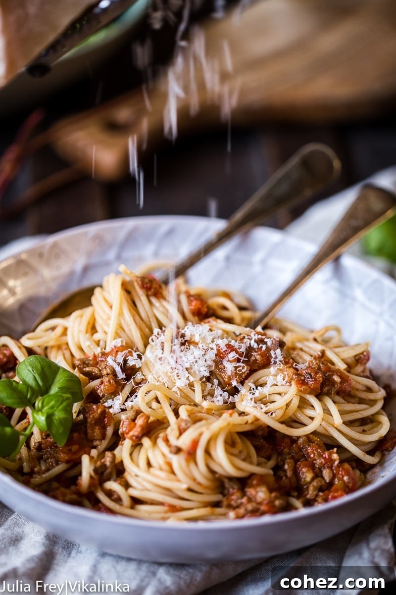 Savory Slow Cooked Bolognese Ragu 7 Close-up of Slow Cooker Beef Bolognese sauce, bubbling gently with its rich texture and color, perfect for pasta.