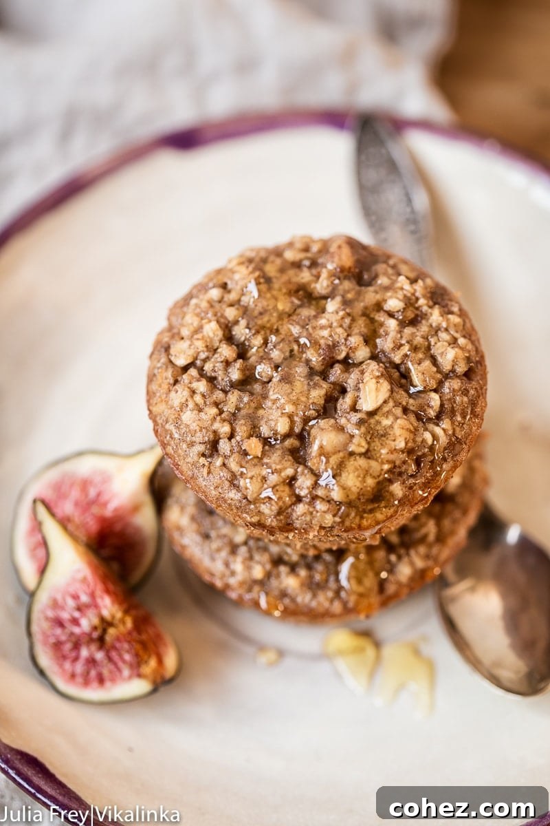A stack of freshly baked Flourless Oatmeal Muffins, showcasing their wholesome texture and golden-brown tops.
