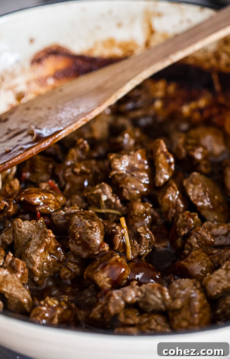 beef stir fry in a white frying pan