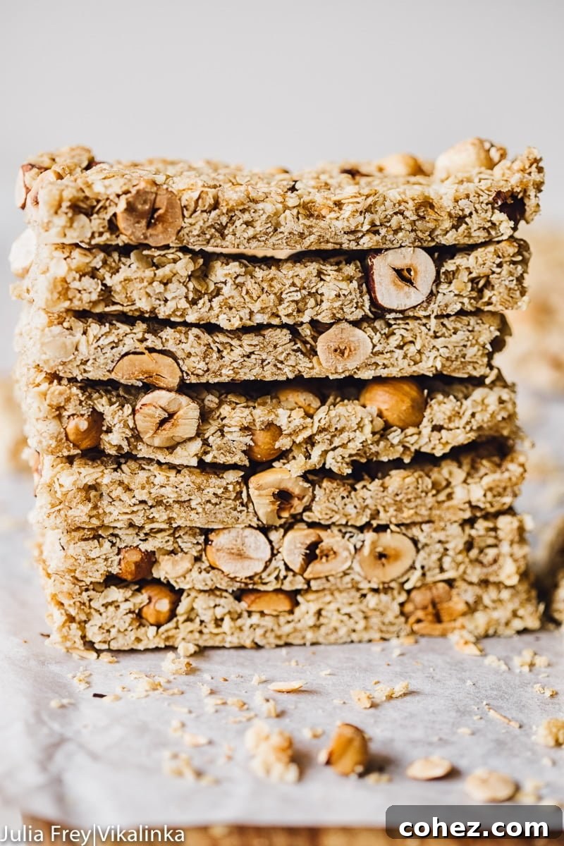 Golden Manuka Granola Bars 2 Stack of granola bars on parchment paper, showcasing their inviting texture