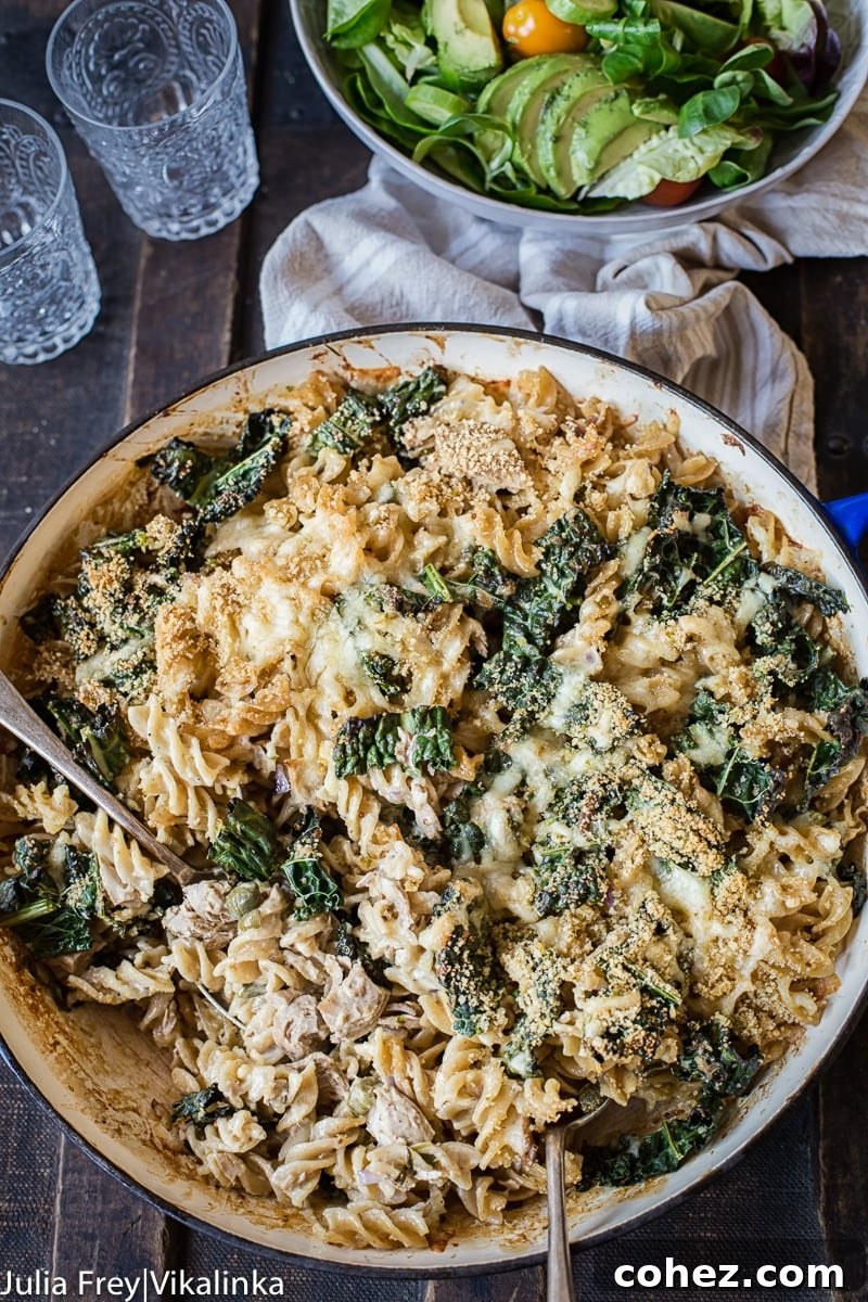 Tuna Noodle Casserole served in a cast iron dish, with a serving spoon