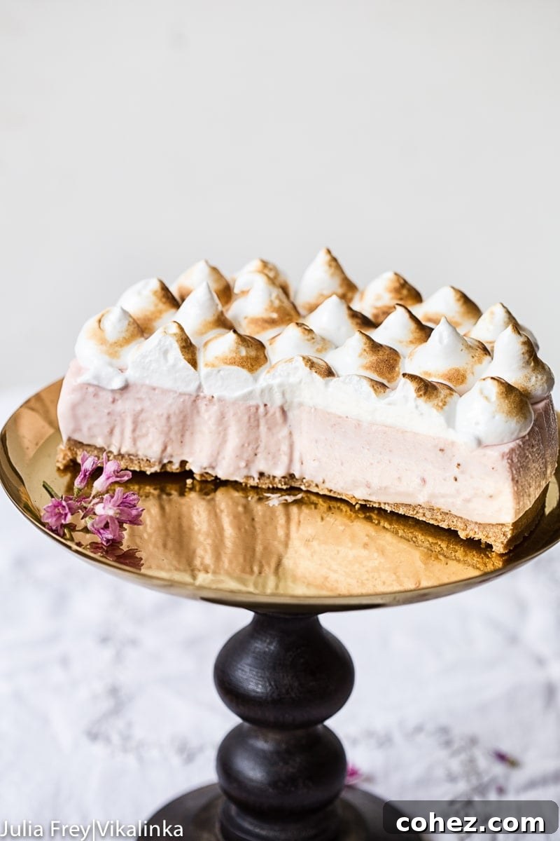 Airy Strawberry Meringue No Bake Cheesecake 9 Side view of Strawberry Meringue Cheesecake with perfect slices removed, showcasing its layers and topping