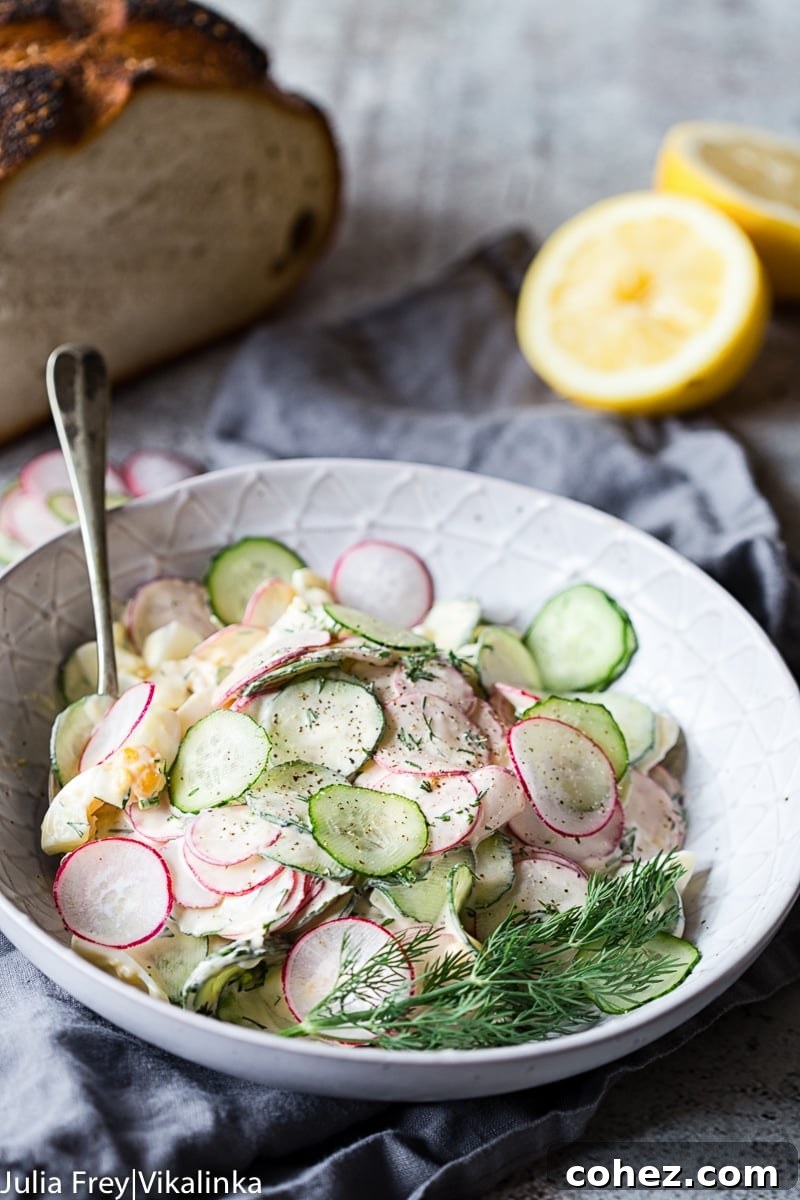 Creamy Dill Cucumber, Radish and Egg Salad served in a white bowl, showcasing the vibrant colors and creamy texture.