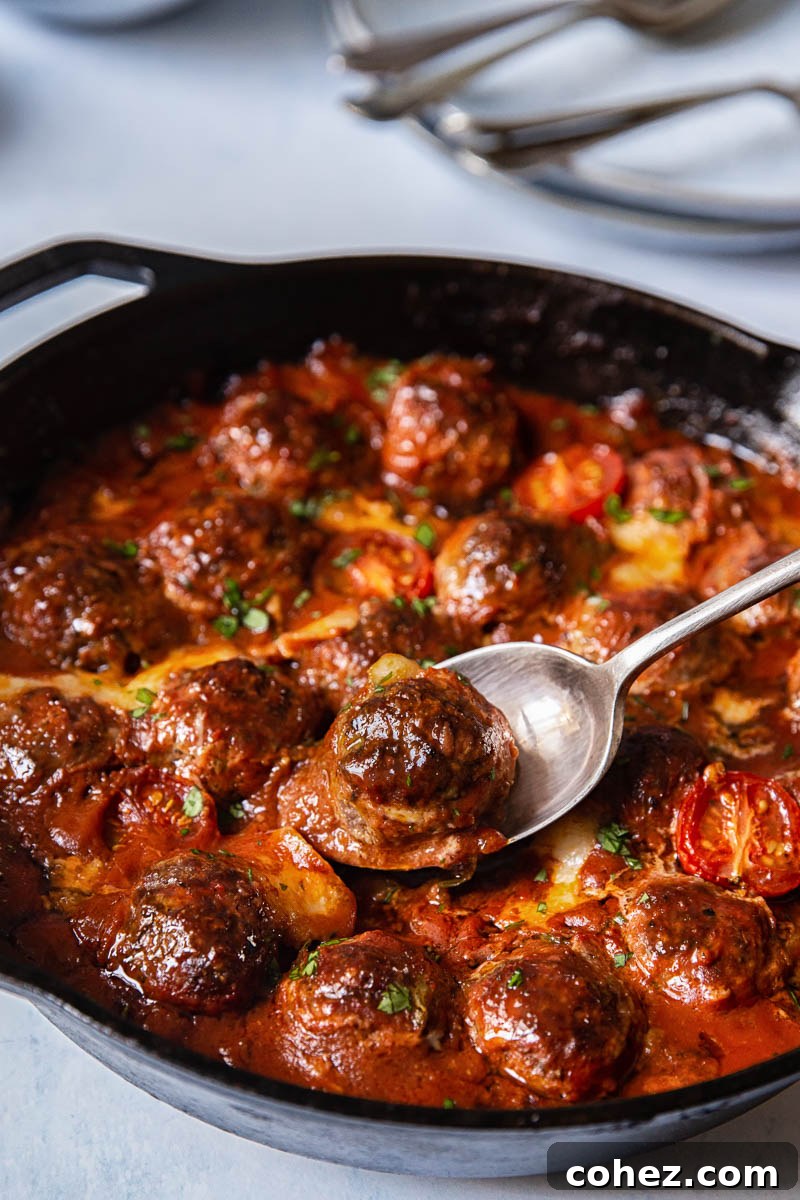 Baked Meatballs with Mozzarella and Arugula in a skillet
