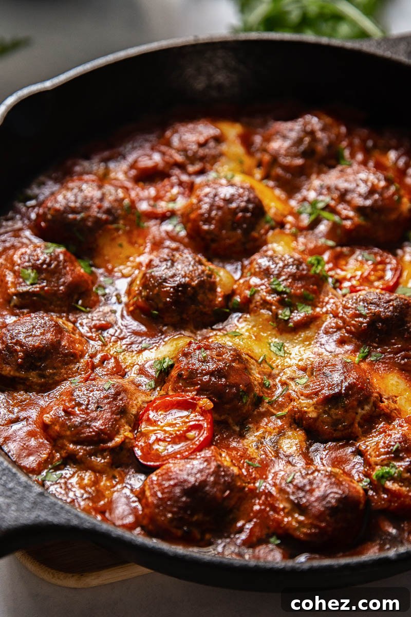 Close-up of baked meatballs covered in mozzarella and tomato sauce