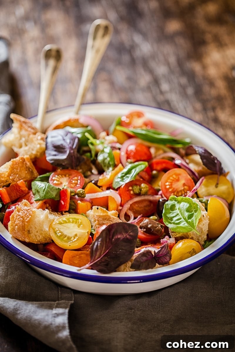 Vibrant Panzanella Salad in a serving bowl, showcasing fresh tomatoes, bread, and basil.