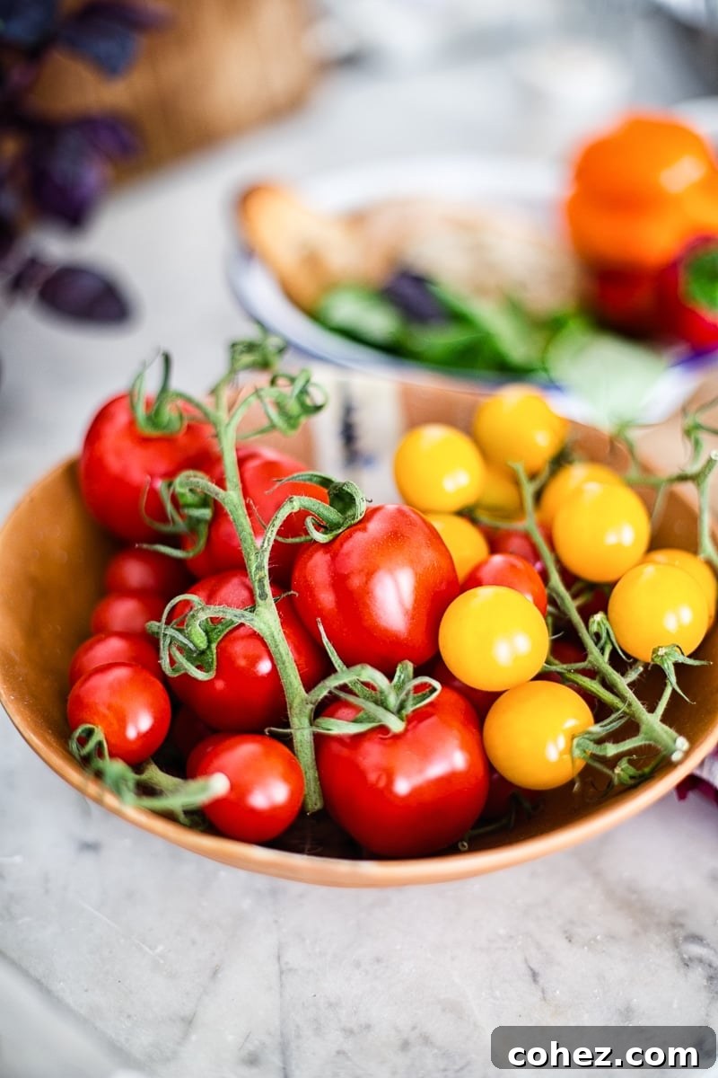 Close-up of vibrant red and yellow tomatoes, freshly picked and ready for Panzanella salad.
