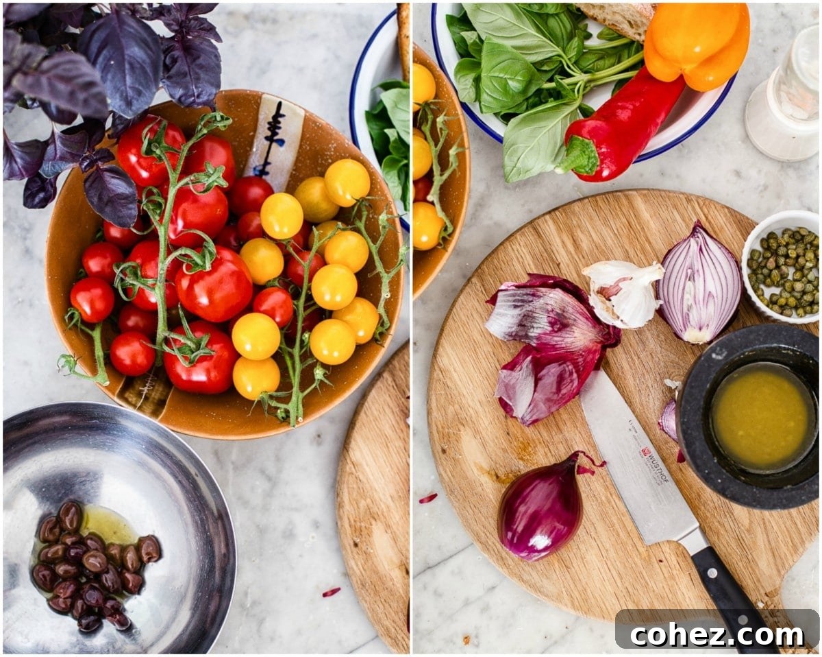 A vibrant flat lay image showcasing all the fresh ingredients for Panzanella salad, including various tomatoes, bread, peppers, basil, and dressing components.