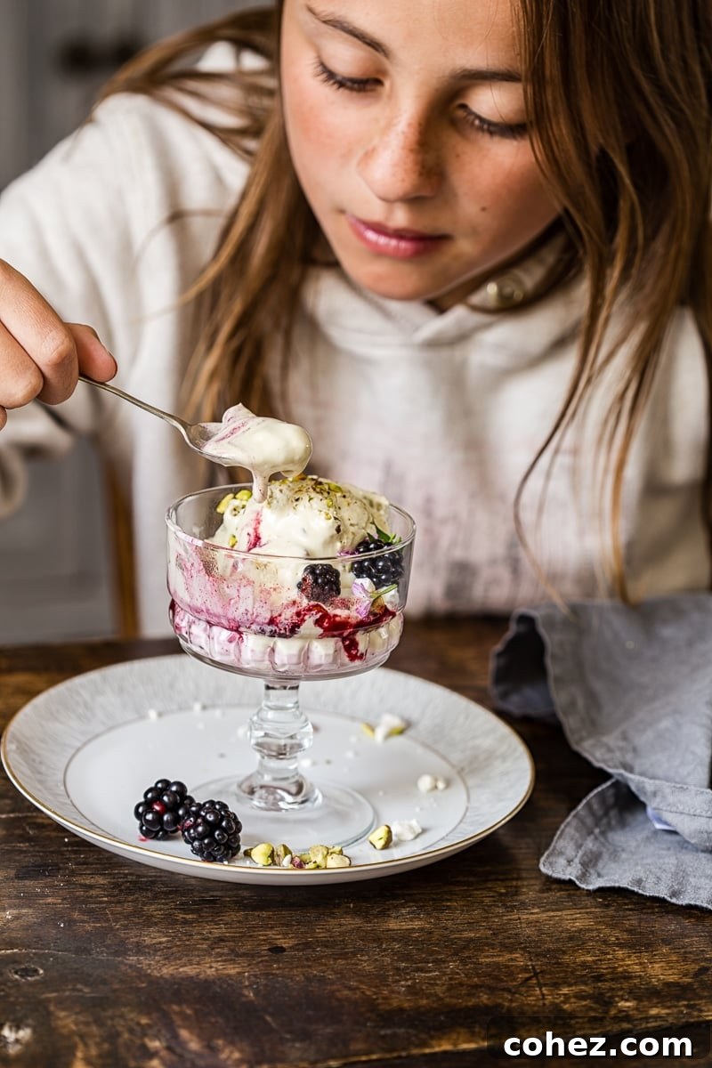 Girl eating the dessert from a glass dish
