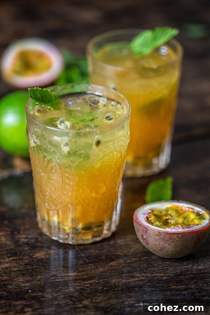 Island Passion Quencher 2 Vibrant Passion Fruit Mojito, garnished with fresh mint and a lime wedge, perfect for summer