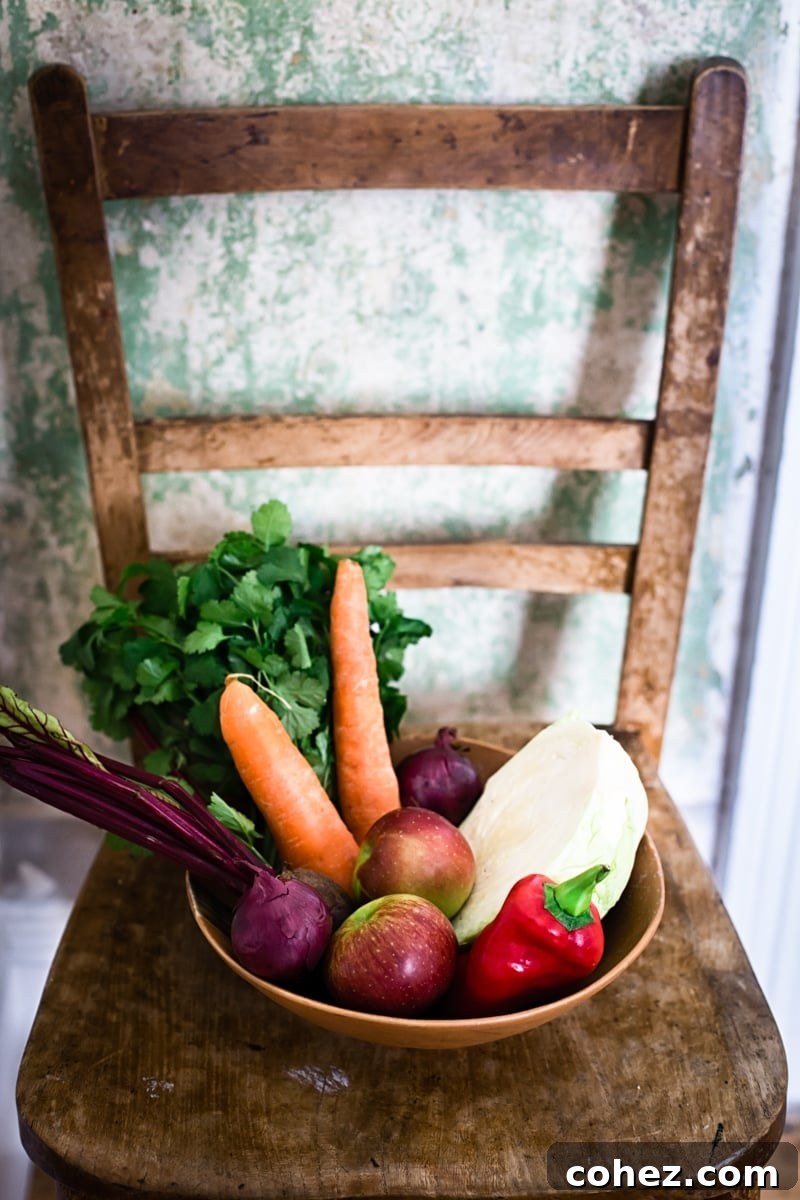 A bowl of shredded colorful vegetables, with a knife and cutting board nearby, suggesting preparation.