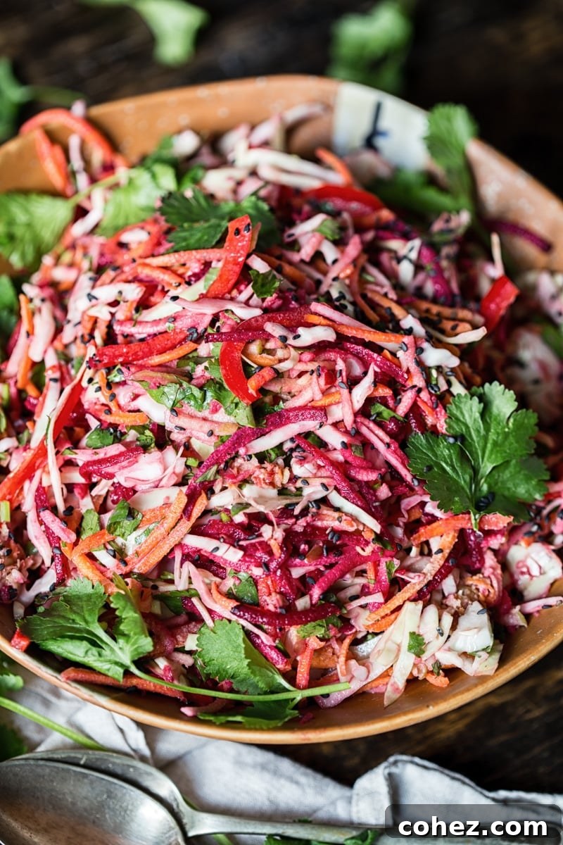 Close-up shot of the vibrant Rainbow Slaw, showing the intricate layers of colorful vegetables.
