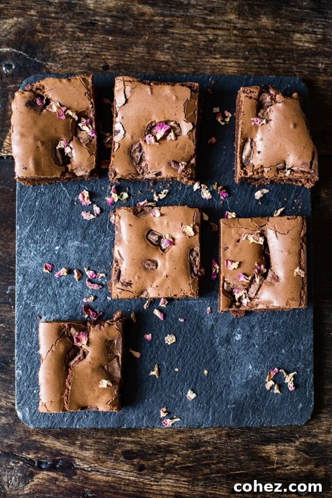 Rosewater Infused Chocolate Brownies 2 Pieces of Turkish delight brownies on a table, showcasing their rich texture and alluring topping