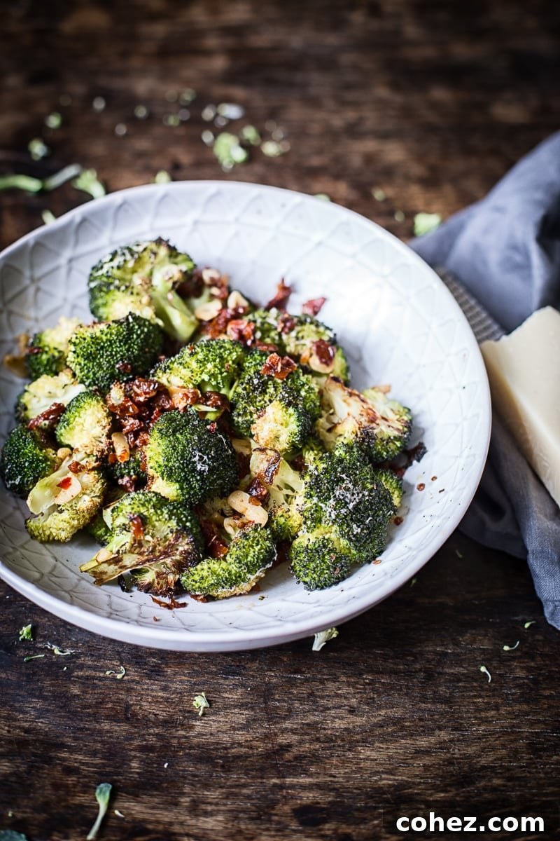 Sun-Kissed Tomato & Parmesan Roasted Broccoli 6 Close-up of roasted Parmesan broccoli with sun-dried tomatoes, garlic, and chilies in a serving bowl
