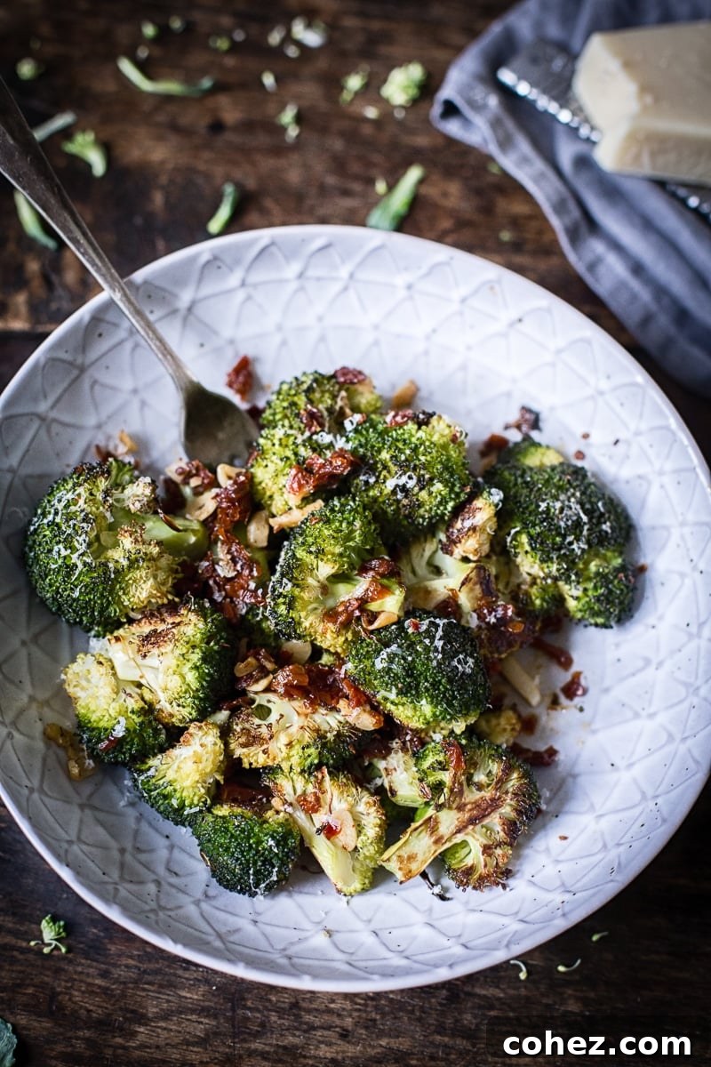 Sun-Kissed Tomato & Parmesan Roasted Broccoli 7 Roasted Parmesan Broccoli with Sun-Dried Tomatoes, Garlic and Chillies, garnished with fresh herbs
